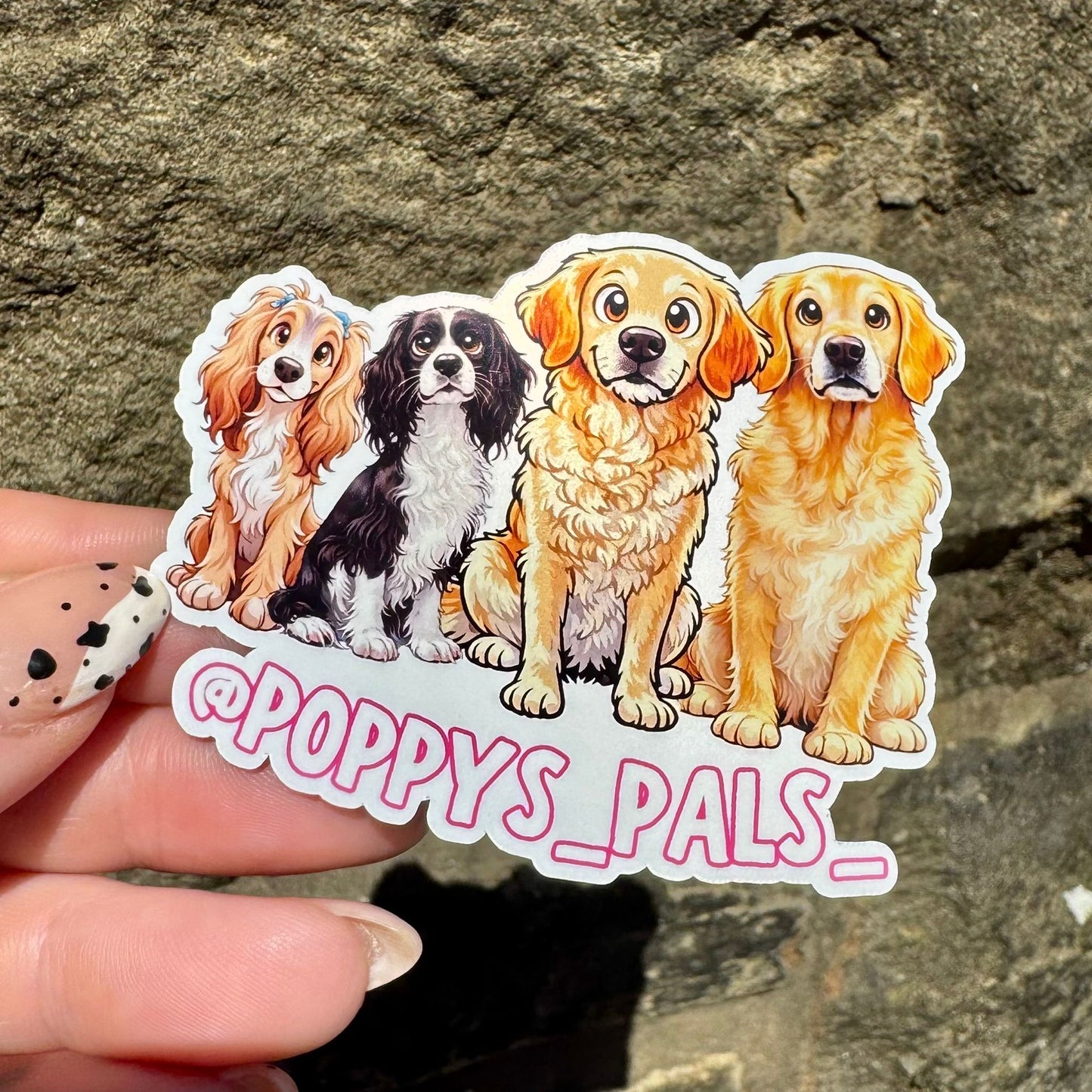 Sticker with illustrations of four dogs held against a stone background