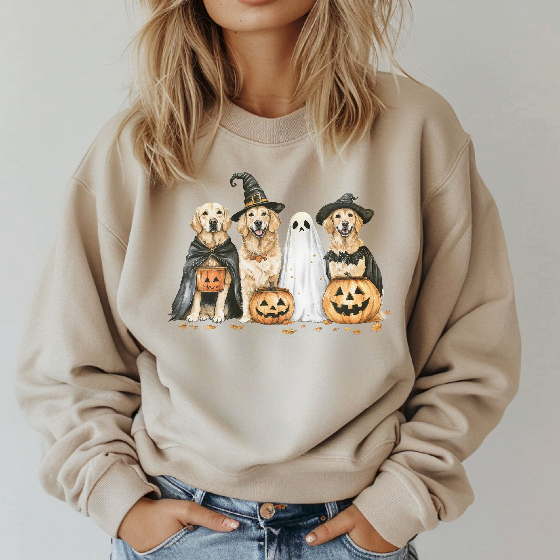 Beige sweatshirt with Halloween-themed design of dogs and ghosts, worn by a person.